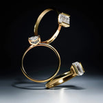 Three Delve Jewellery golden rings with lab-grown diamond accents on a dark background